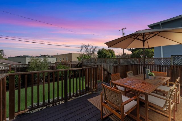 a view of balcony with wooden floor and outdoor seating