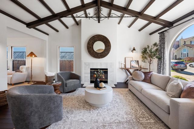 a living room with furniture a fireplace and a table