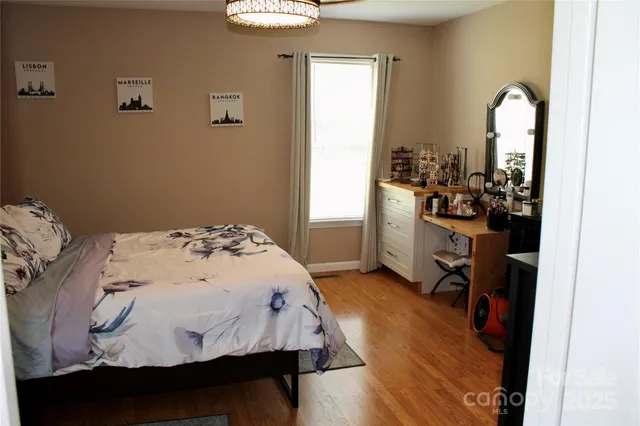 a bed sitting in a bedroom next to a window