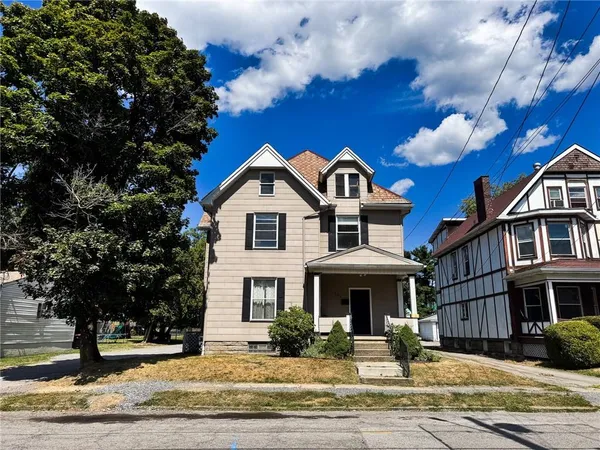 a front view of a house with a yard