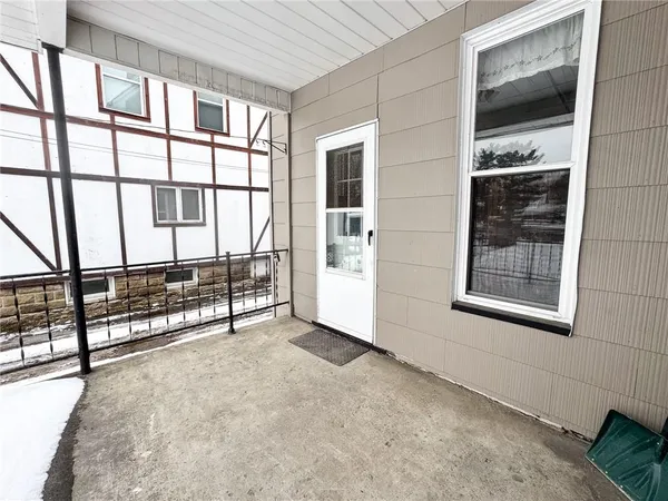 a view of a balcony with a floor to ceiling window and wooden fence