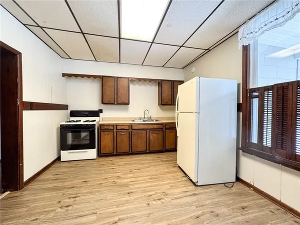 a view of a refrigerator with wooden floor