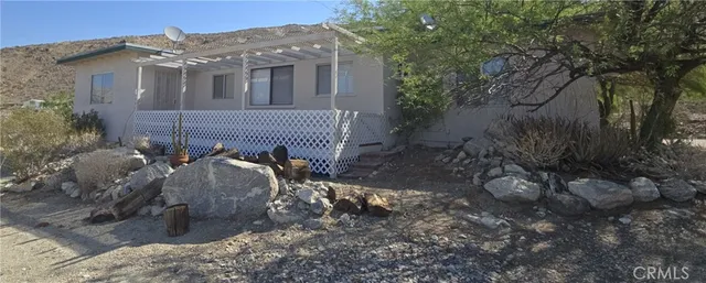 a view of a house with a yard and mountain view