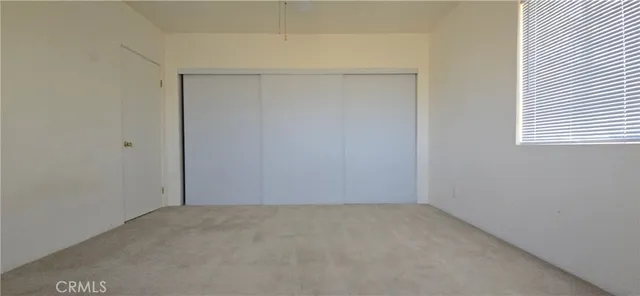 a view of a hallway with a chandelier fan