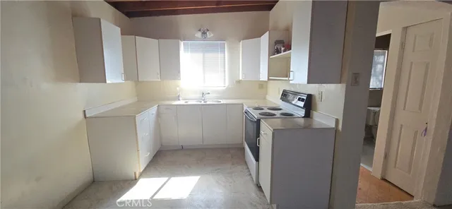 a utility room with cabinets washer and dryer
