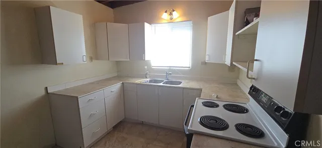 a utility room with cabinets washer and dryer