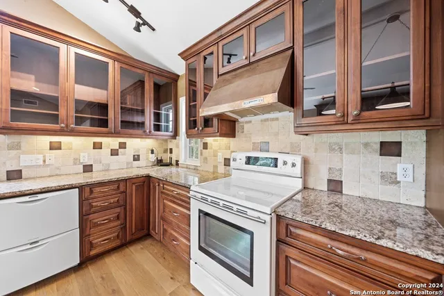 a kitchen with stainless steel appliances granite countertop a stove and a sink