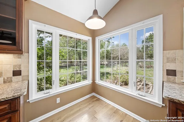 a view of open kitchen with granite countertop a large window