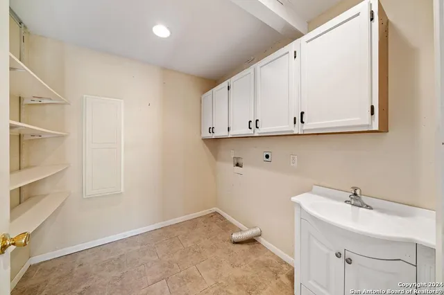 a view of a storage and utility room with a sink