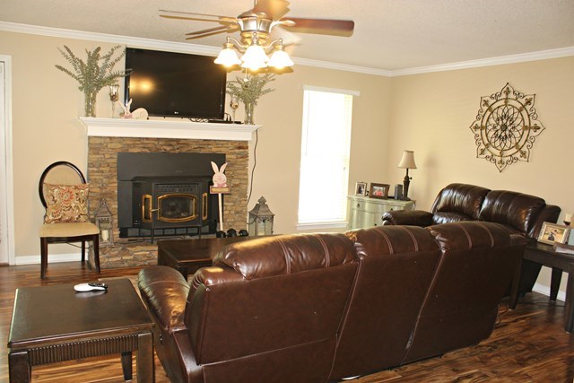 1935 Reedy Creek Road Forsyth, GA 31029 - Photo 2 of 14 a living room with furniture a flat screen tv and a fireplace