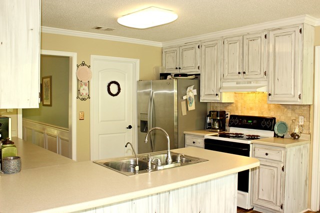 1935 Reedy Creek Road Forsyth, GA 31029 - Photo 4 of 14 a kitchen with stainless steel appliances granite countertop a sink a stove and refrigerator