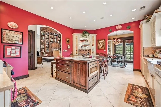 a kitchen with stainless steel appliances kitchen island granite countertop a sink and cabinets