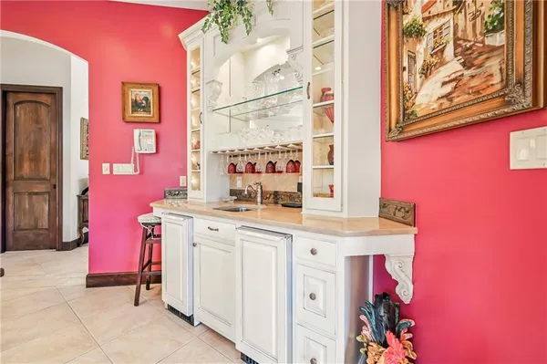 a room with cabinets a sink and a window