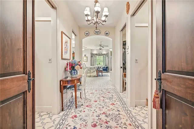 a view of a dining room with furniture and a chandelier