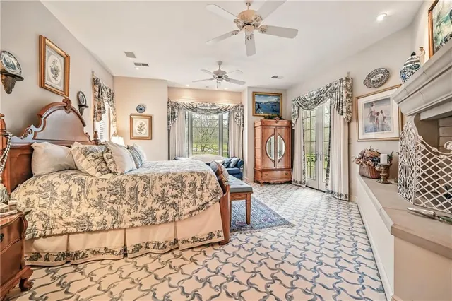 a spacious bedroom with a large bed and a chandelier