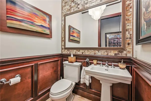 a bathroom with a sink a toilet and mirror