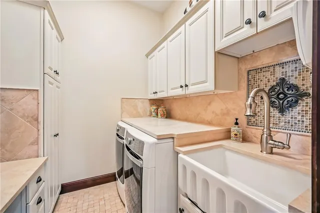 a utility room with a sink a washer and dryer