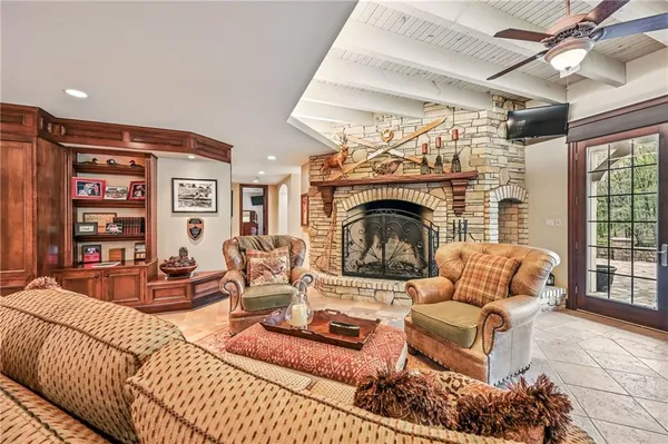 a living room with furniture a rug and a fireplace