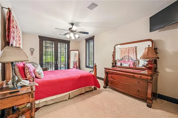 a bedroom with a bed and a chandelier