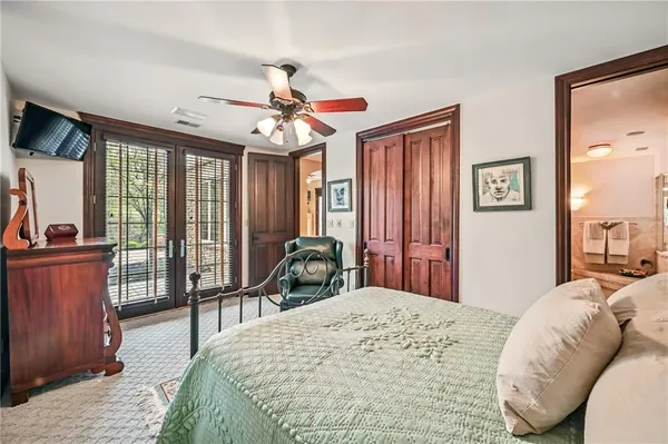 a bedroom with a bed and a large window