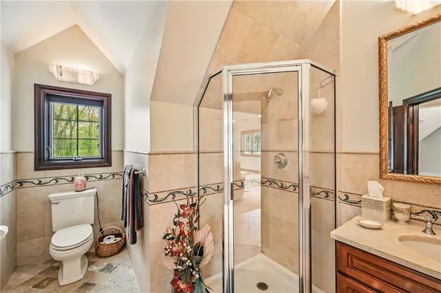 a bathroom with a granite countertop sink toilet and shower