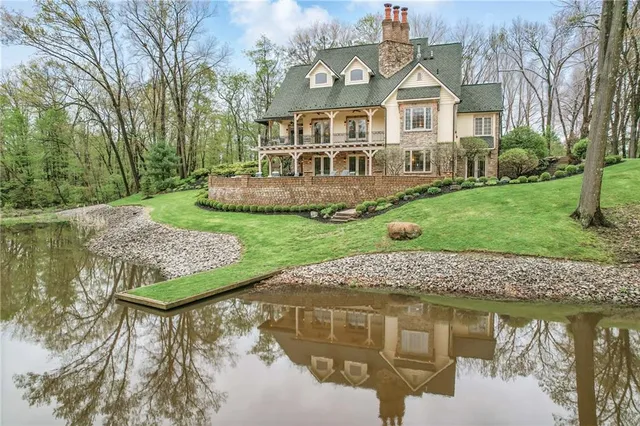 a view of a house with a yard balcony and sitting area