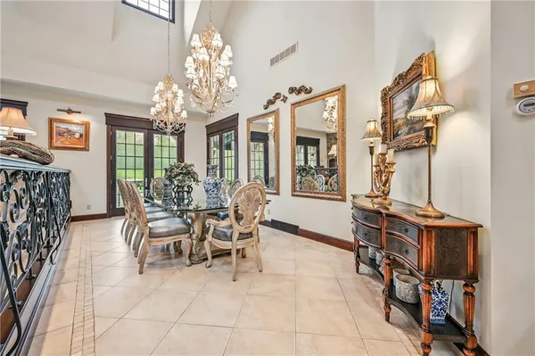 a view of a dining room with furniture and a chandelier