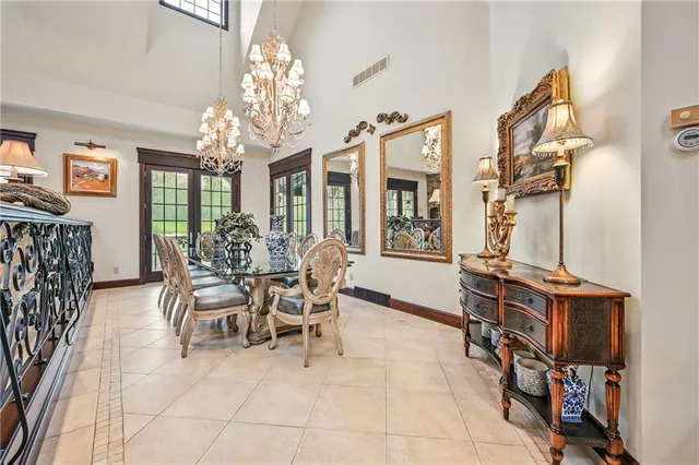 a view of a dining room with furniture and a chandelier