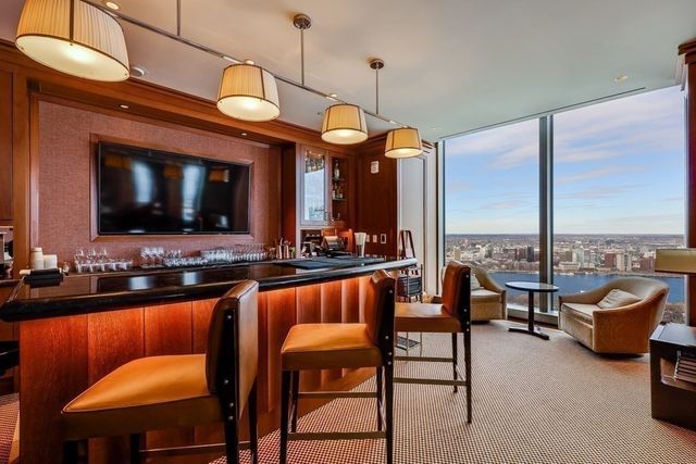 a living room with furniture a flat screen tv and a large window