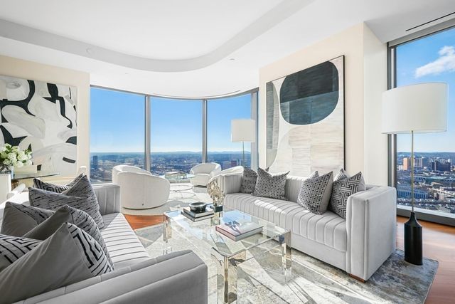 a living room with furniture and a painting on the wall