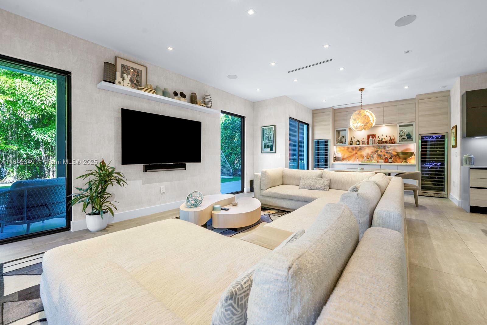 7900 Southwest 54th Avenue Miami, FL 33143 - Photo 17 of 63 a living room with furniture and a flat screen tv