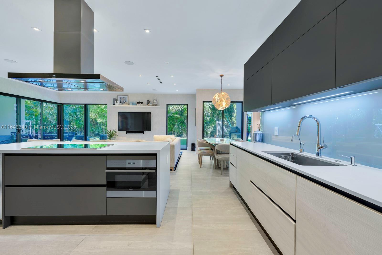 7900 Southwest 54th Avenue Miami, FL 33143 - Photo 24 of 63 a kitchen with stainless steel appliances a stove and more cabinets