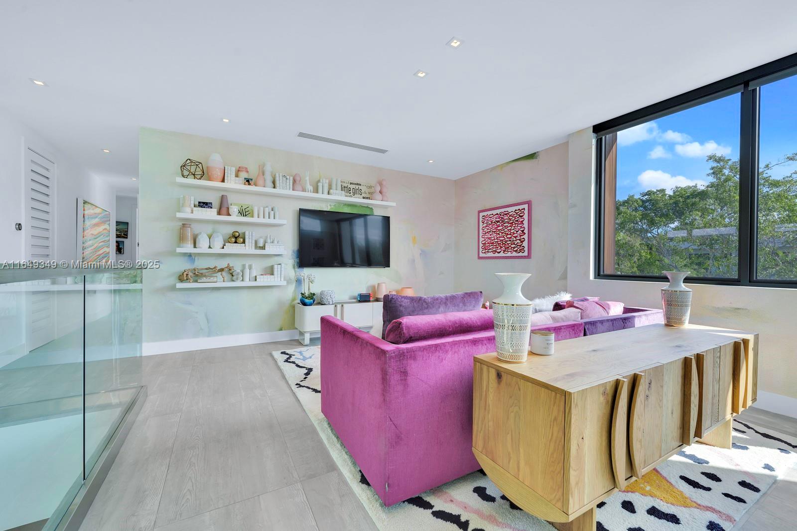 7900 Southwest 54th Avenue Miami, FL 33143 - Photo 30 of 63 a living room with furniture and a flat screen tv