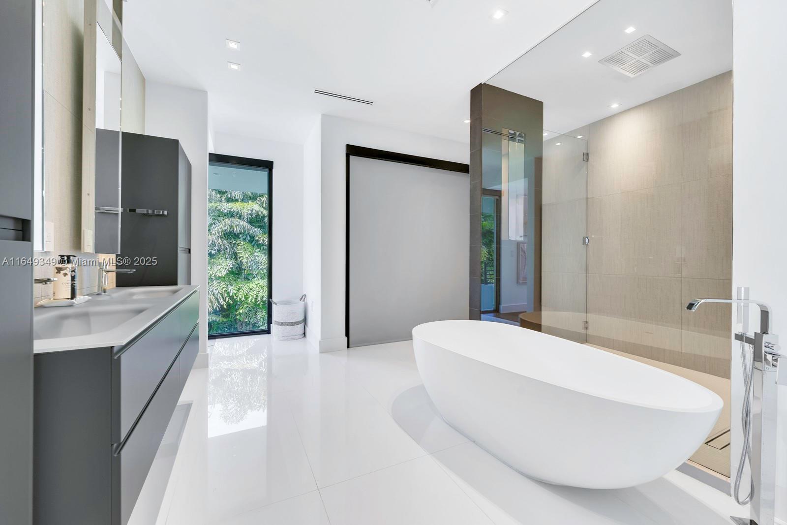 7900 Southwest 54th Avenue Miami, FL 33143 - Photo 50 of 63 a spacious bathroom with a double vanity sink and a large mirror