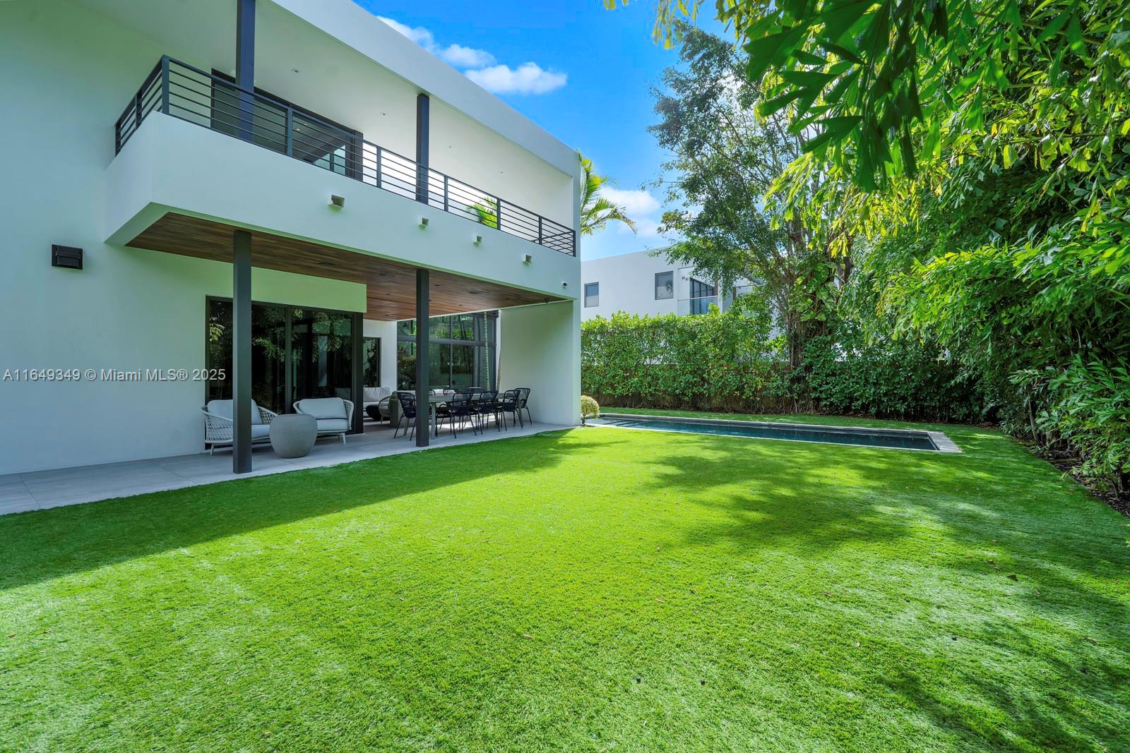 7900 Southwest 54th Avenue Miami, FL 33143 - Photo 59 of 63 a view of a patio with a table and chairs under an umbrella