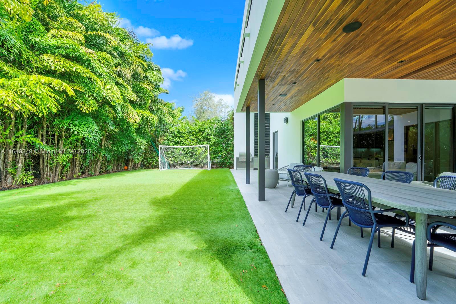 7900 Southwest 54th Avenue Miami, FL 33143 - Photo 60 of 63 a view of a patio with table and chairs potted plants and floor to ceiling window