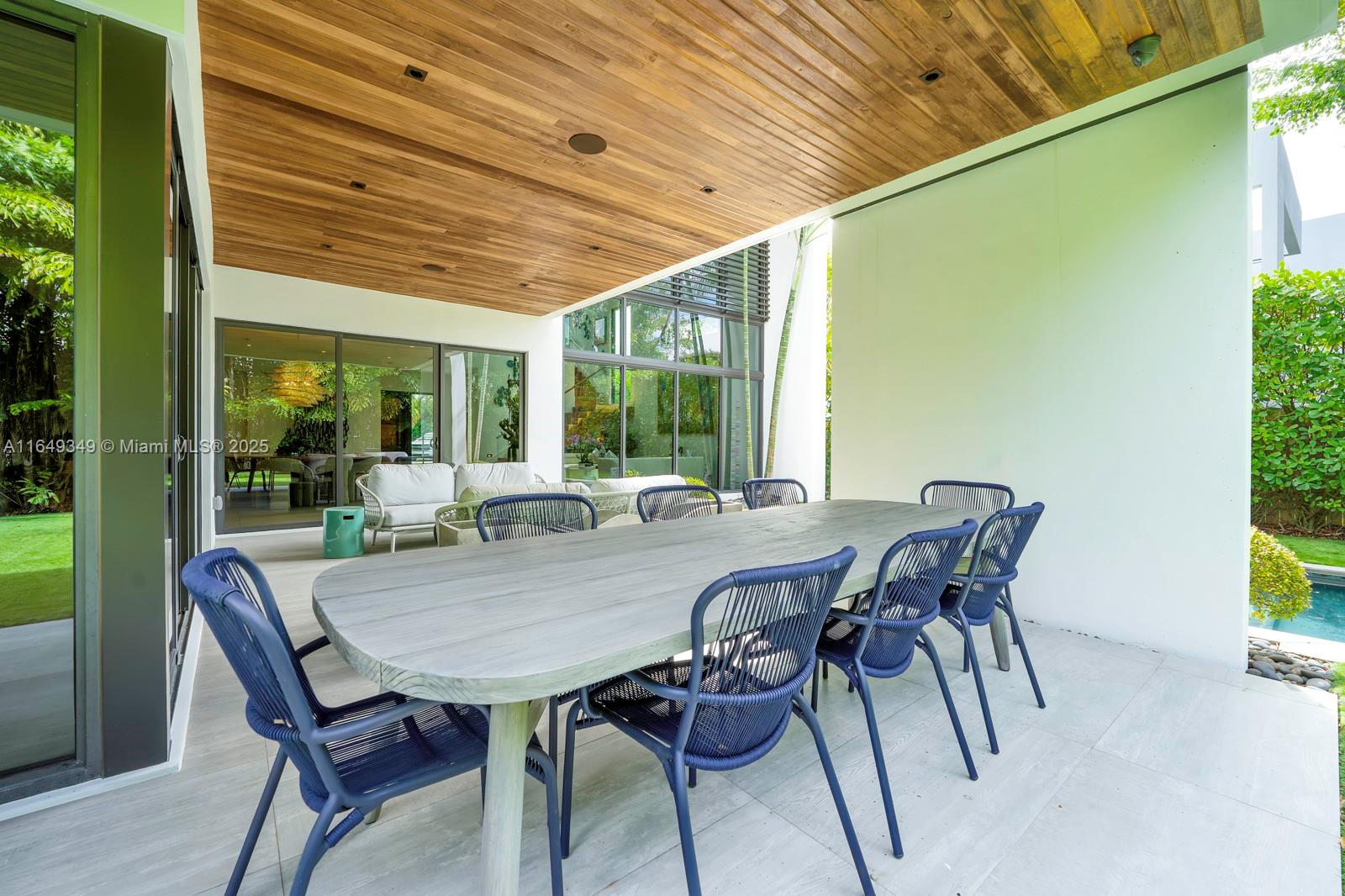 7900 Southwest 54th Avenue Miami, FL 33143 - Photo 61 of 63 a view of a patio with table and chairs and potted plants