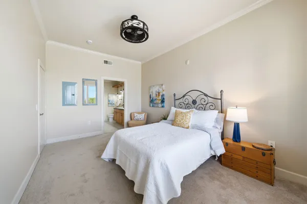 a bedroom with a bed and a chandelier