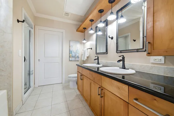 a spacious bathroom with a double vanity sink and mirror
