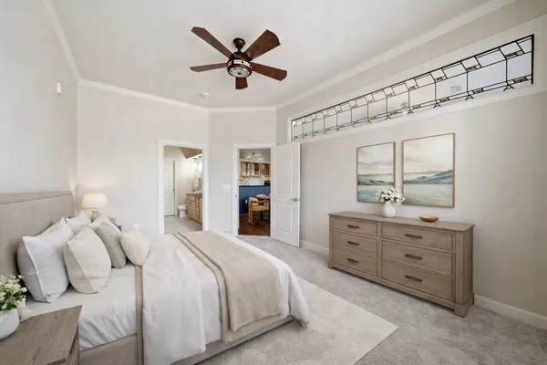 a spacious bedroom with a large bed and a chandelier