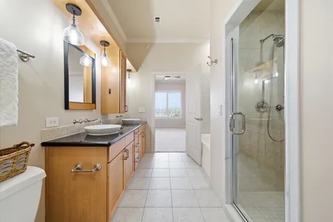 a bathroom with a granite countertop sink a mirror and a shower