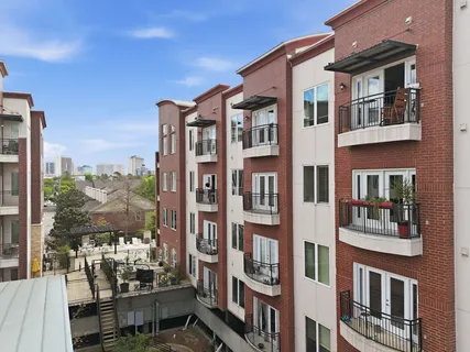 a front view of a residential apartment building with a yard