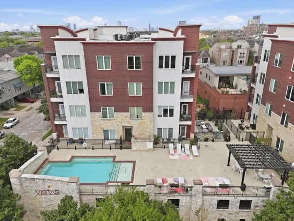 a view of a building with yard and sitting area