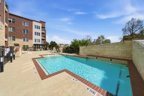 a view of a building with yard and sitting area