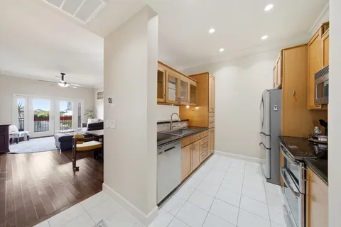 a kitchen with stainless steel appliances granite countertop a refrigerator and a sink