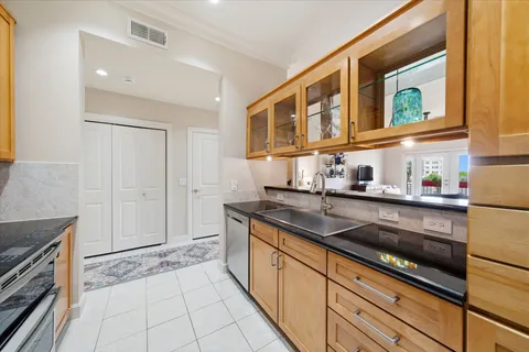 a kitchen with stainless steel appliances granite countertop a sink and cabinets