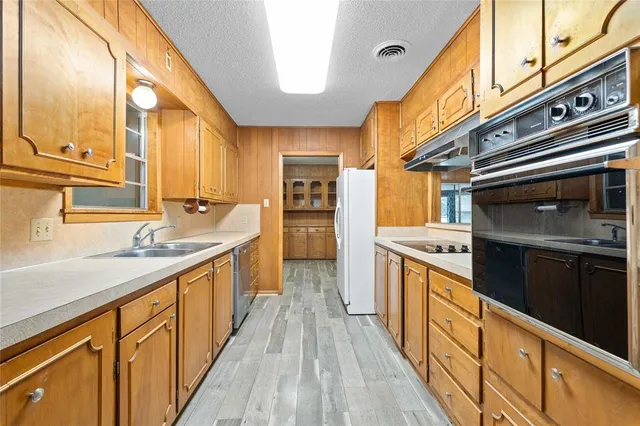 a kitchen with stainless steel appliances granite countertop a stove and a sink