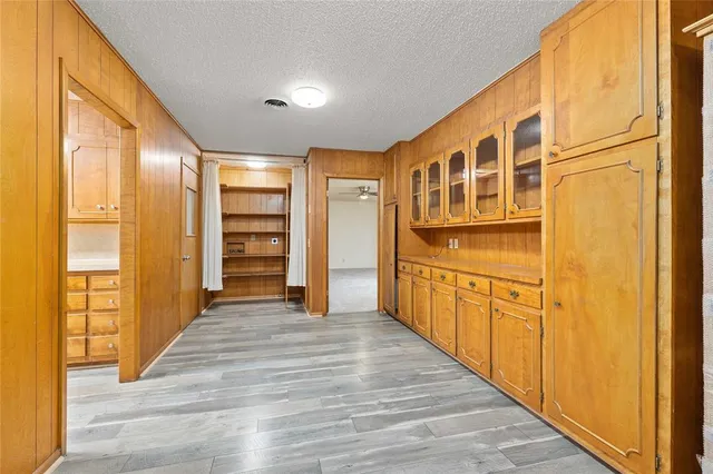 a view of a hallway with wooden staircase