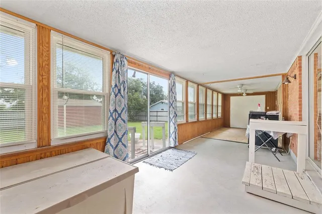 a living room filled with furniture and a large window
