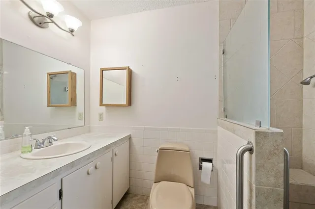 a bathroom with a toilet sink and mirror